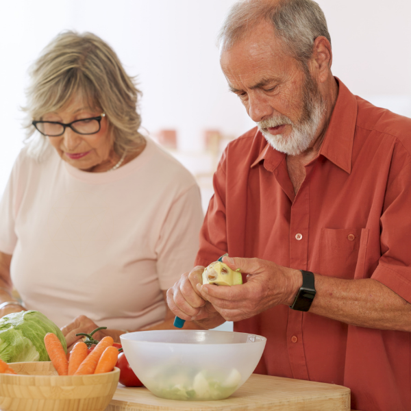 An older couple preparing fresh food together in their kitchen